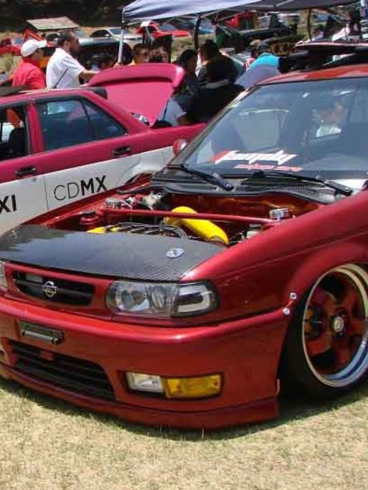 several cars parked next to each other at a car show