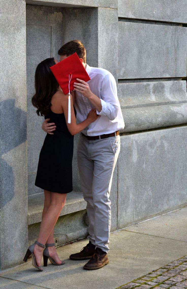 a man and woman kissing on the street