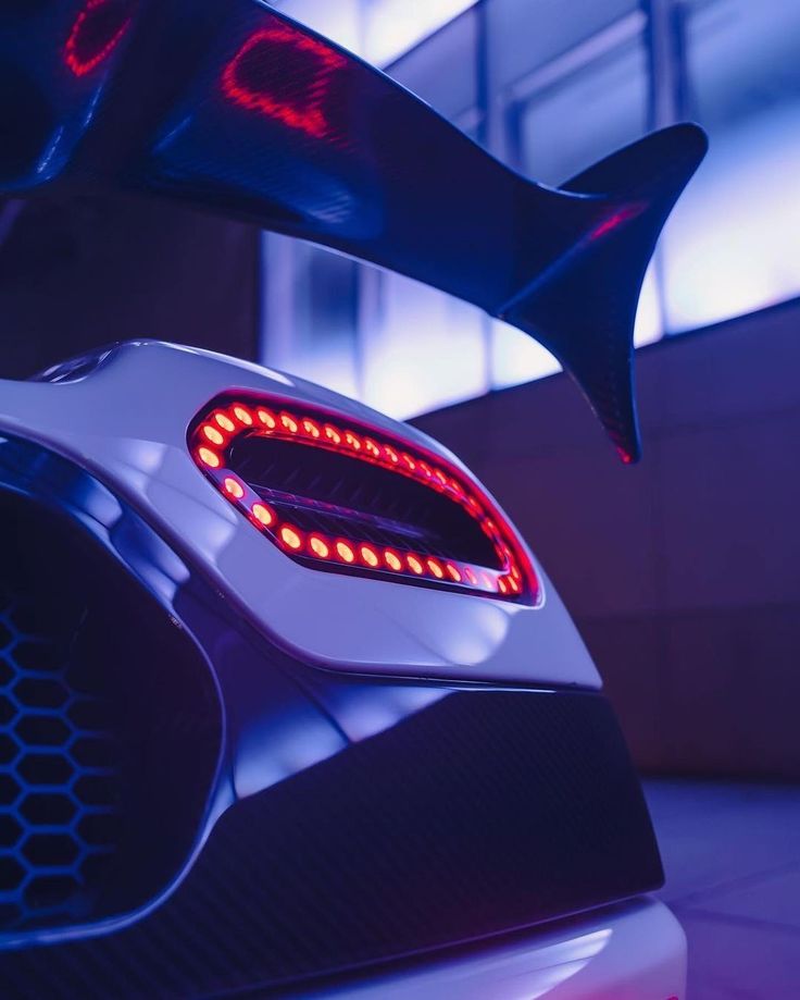 the tail lights on this futuristic car are red and white, while the tail light is blue