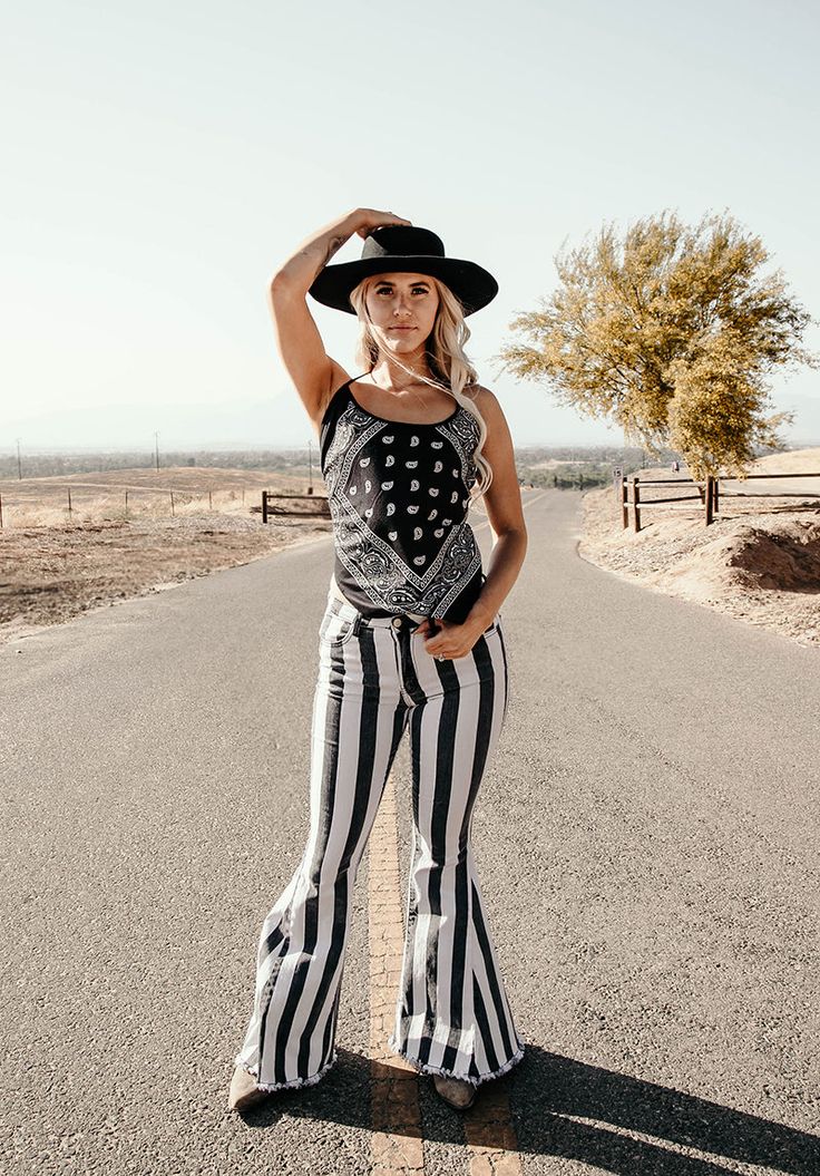 This flattering and comfy black bandana halter top is crafted with 100% rayon one-size-fit-all with adjustable tie back, model is 5'8" with 33, 25" and 33" measurements. One size This black halter tank top is made in the U.S.A. Our guarantee to you: If you are not 100% satisfied with your purchase, you can return your order to us within 30 days for a refund, exchange or store credit. Shipping charges are not refundable. (Returns must be unworn, in the state you received them, and in the original Trendy Stretch Tank Top For Festival, Trendy Fitted Tank Top For Music Festival, Trendy Bandana For Summer, One Size Fits Most, Fitted Tank Top For Summer Festivals, Sleeveless Summer Top With Bandana Print, Summer Sleeveless Top With Bandana Print, Casual Summer Festival Bandana, Fitted Casual Bandana For Summer, Casual Summer Vacation Bandana