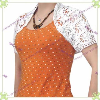 a woman wearing an orange top with white lace