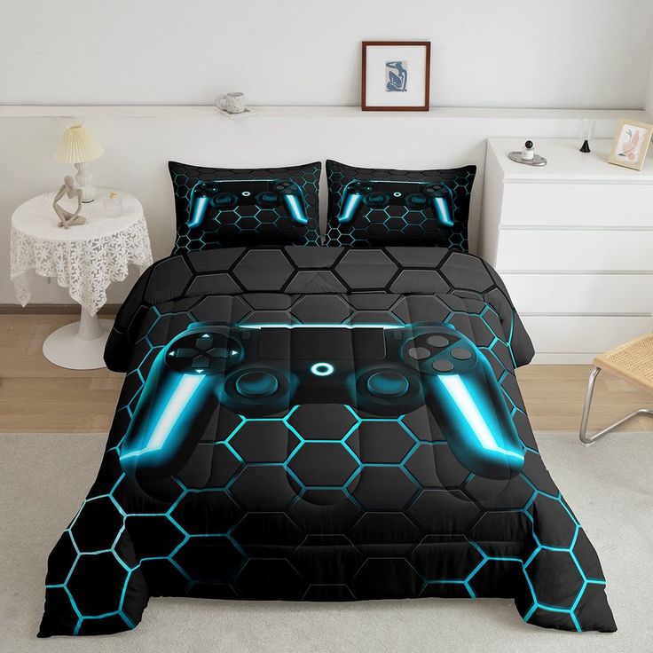 a bed covered in black and blue comforters with neon lights on the headboard