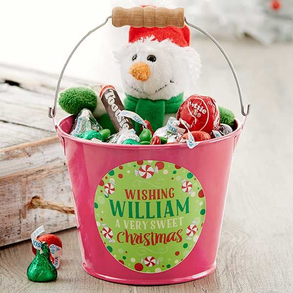 a bucket filled with candy and a stuffed snowman