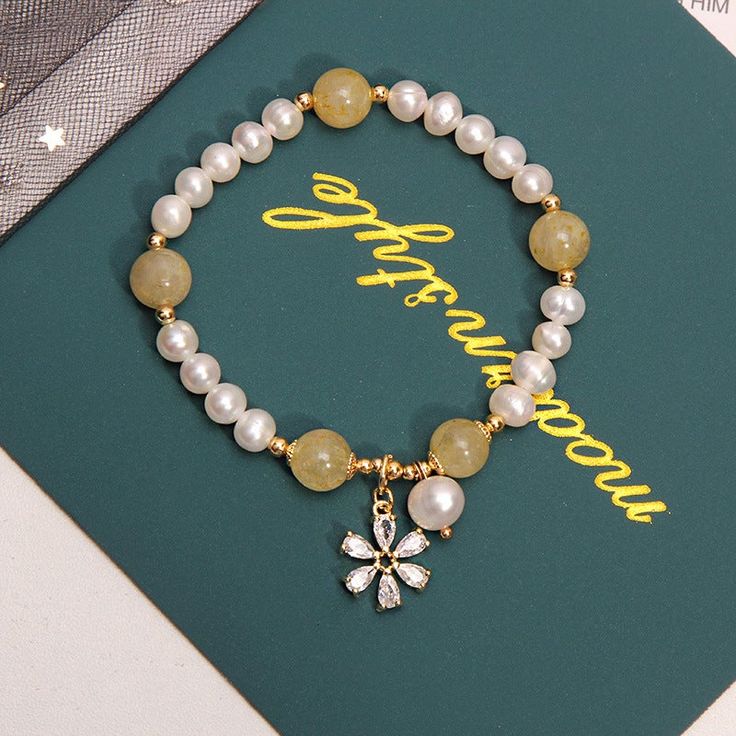 This beautiful Freshwater pearl bracelet ranges between 7-8mm in size and consists of beautiful and lustrous pearls in AAAA+ quality. All pearls in this bracelet are round and are strung with silk thread and double-knotted between each pearl. Known as the 'icon' of cultured pearls, Freshwater pearls have graced the necks, ears, fingers, and wrists of women for decades. Huge Tomato imports their Freshwater pearls from the Freshwater rs of Japan, grown in the Pinctada fucata oyster. All of our Fre Gold Pearl Flower Bracelets, Elegant Yellow Flower Bracelets, Elegant Yellow Flower Bracelet, Elegant Yellow Bracelets With 8mm Beads, Elegant Pearl Jewelry, Gold Pearl Bracelet, Pearl Bracelet Gold, Cultured Pearl Bracelet, Born In June