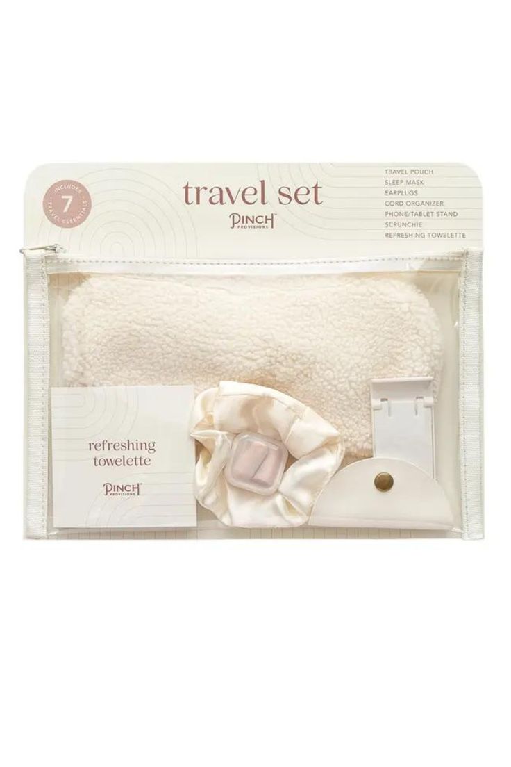 the travel set in its packaging is white and has two pieces of cloth on it