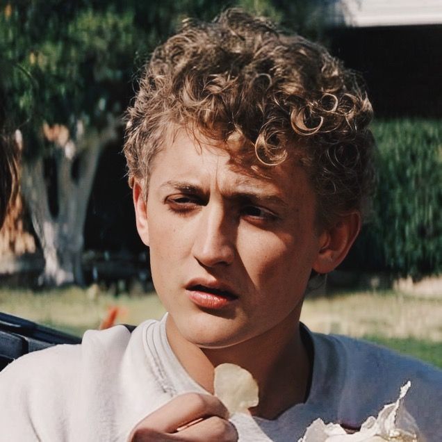 a young man eating an ice cream sundae