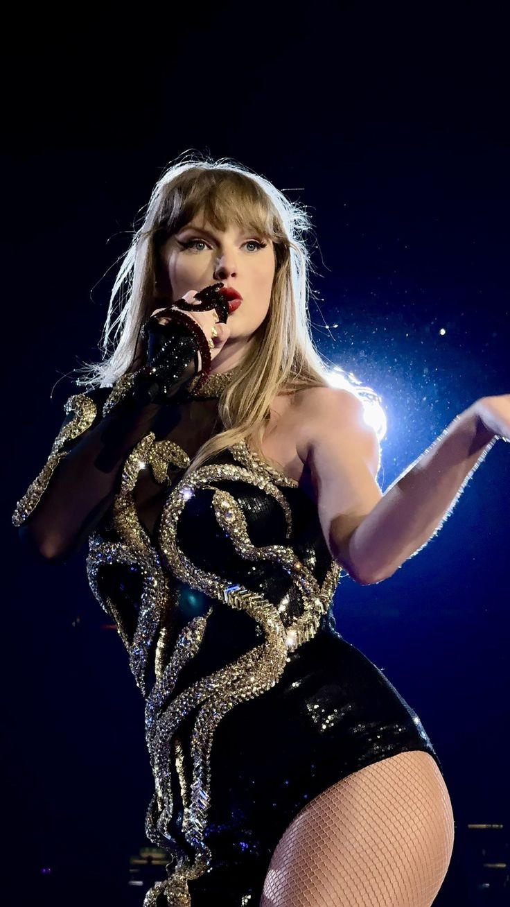 taylor swift performing on stage at the concert