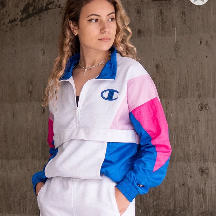 -Brand New With Tags Attached -Mixed Construction With Grey Sweatshirt-Style Chest And Multi-Colored Windbreaker Panels In Pink And Blue Throughout -Features Elastic Sleeve Cuffs And Bottom Hem, Kangaroo Pouch Pocket, Quarter Zip-Up Closure With Mock Neck, And Champion Logo At The Left Chest -83% Cotton, 17% Polyester Casual Pink Half-zip Outerwear, White Half-zip Sweatshirt For Spring, Sporty Pink Track Jacket With Pockets, Fitted Pink Casual Track Jacket, Pink Sportswear Outerwear For Spring, Trendy Pink Long Sleeve Track Jacket, Casual Pink Cotton Track Jacket, Sporty Pink Sweatshirt With Pockets, Sporty Pink Tops With Pockets