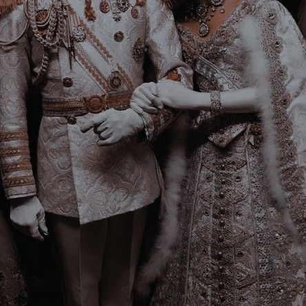 a man and woman dressed in elaborate clothing