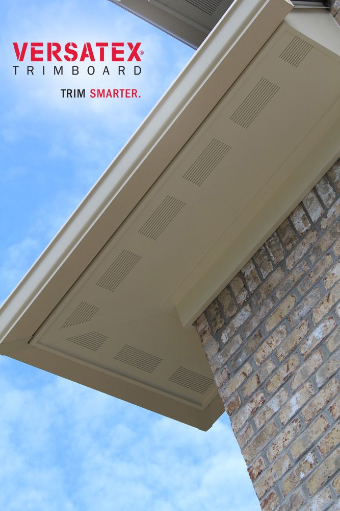 the corner of a brick building with a blue sky in the backgrounge