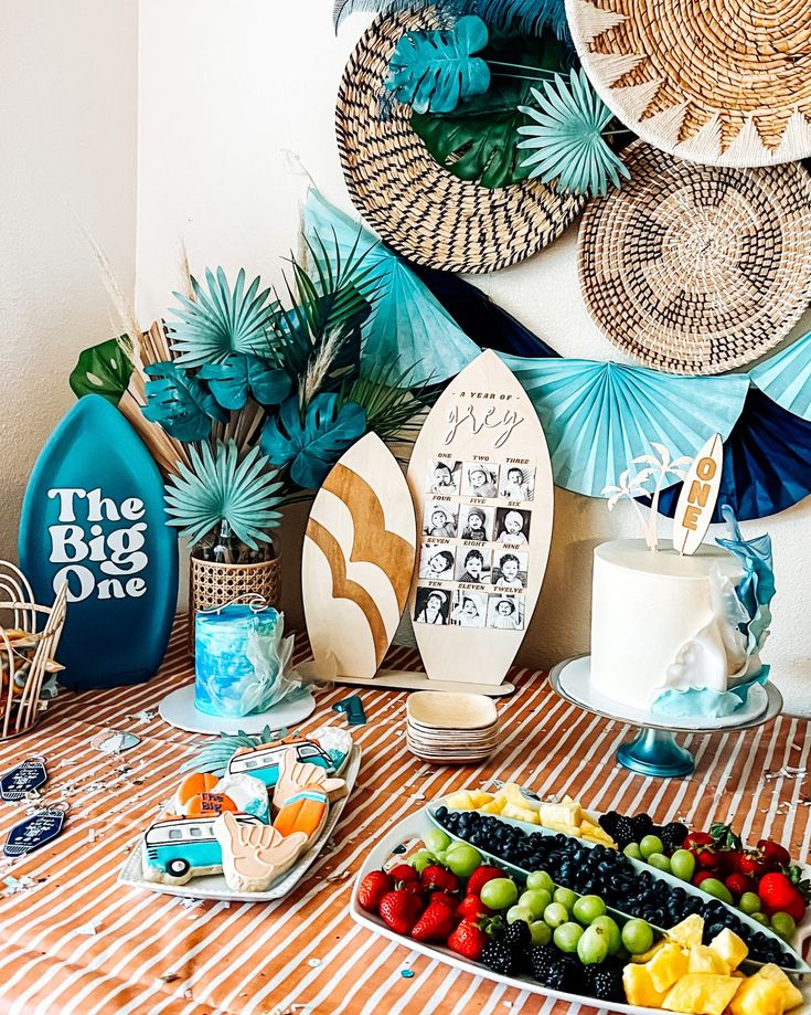 a table topped with plates and bowls filled with fruit on top of a striped table cloth