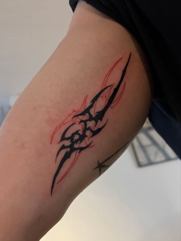 a close up of a person's arm with a tattoo design on the arm