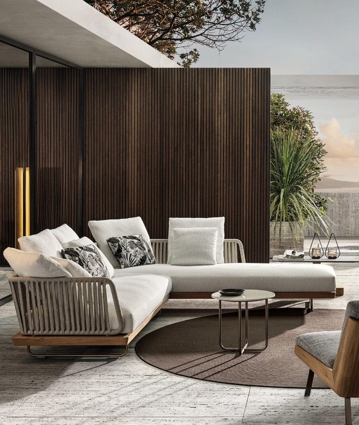 a modern living room with wood paneling and white couches in front of a large window