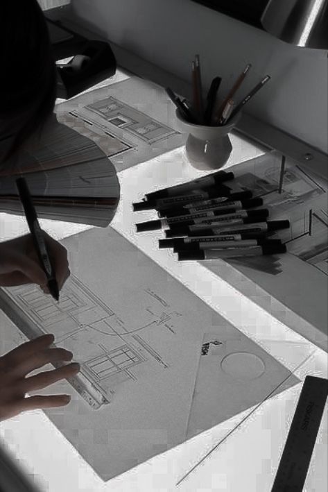 a person is working on some architectural drawings