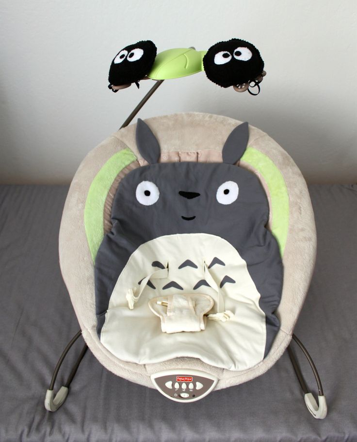 a baby bouncer with two stuffed animals on it's back and the words diy, totoro - themed baby bouncer