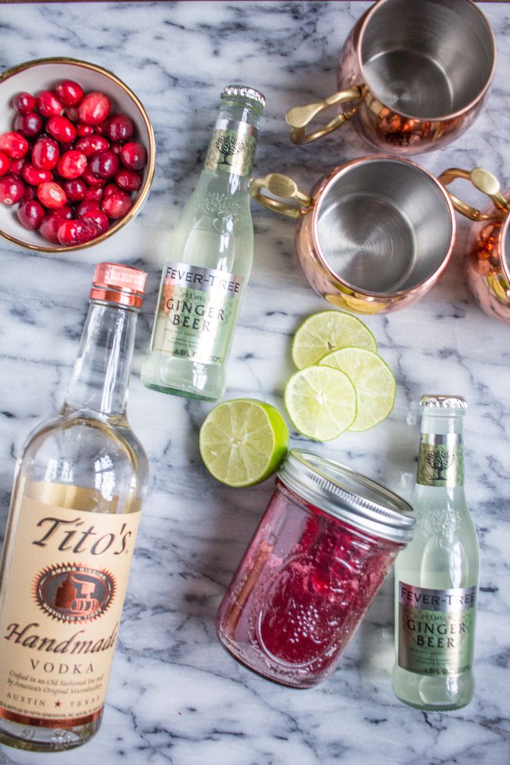 the ingredients to make cranberry lemonade are laid out on a marble counter top