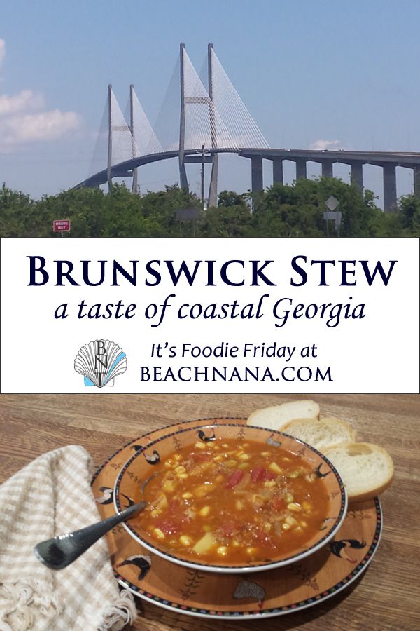 a bowl of soup and some bread on a table with a bridge in the background