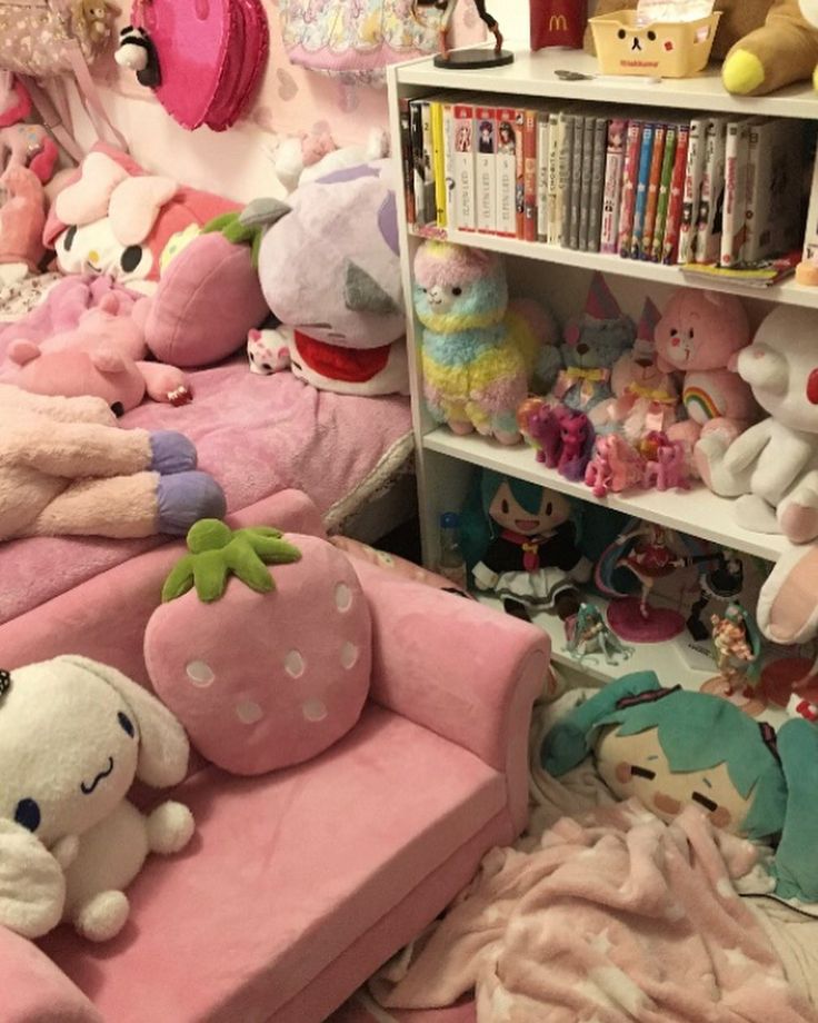 a room filled with lots of stuffed animals next to a book shelf full of books