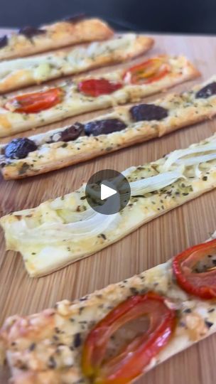 several slices of flat bread with tomatoes and olives