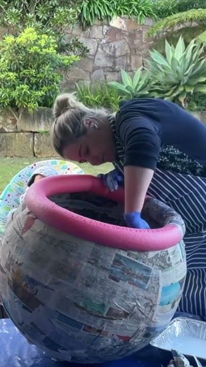 a woman is playing with an inflatable pool