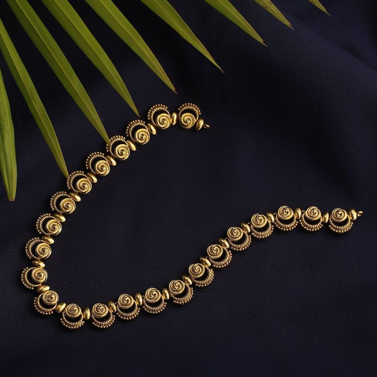 Description: This necklace, Priam, is the best example of simplicity. It is raw and traditional with delicate tribal motifs used to accentuate the look. It is crafted in gold plated with oxidized finish to give the definite earthy charm. It is beautifully framed to feel light around your neck. Details & Specifications: Materials used: Brass Alloy with Antique Gold platting Weight – Necklace-26 Length – Necklace-13 Make it custom Want to make it a custom necklace? Sure! Reach out to us at support Elegant Brass Necklaces With Tilla Detail, Elegant Brass Necklaces With Tilla, Temple Jewelry Necklace In Yellow Gold Brass, Gold Long Tilla Necklace, Yellow Gold Brass Temple Jewelry Necklace, Gold Spiritual Pendant Choker, Antique Gold Brass Necklace For Festive Occasions, Spiritual Gold Pendant Choker, Gold Oxidized Temple Jewelry Necklace