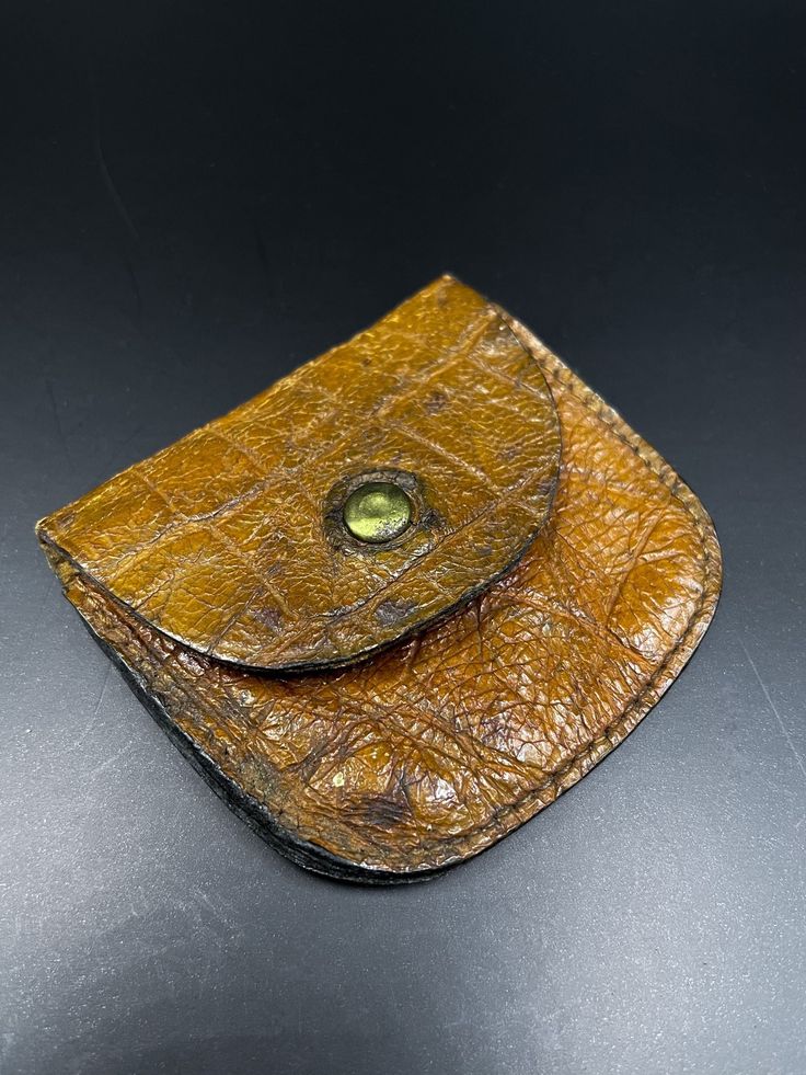 a brown leather wallet sitting on top of a table