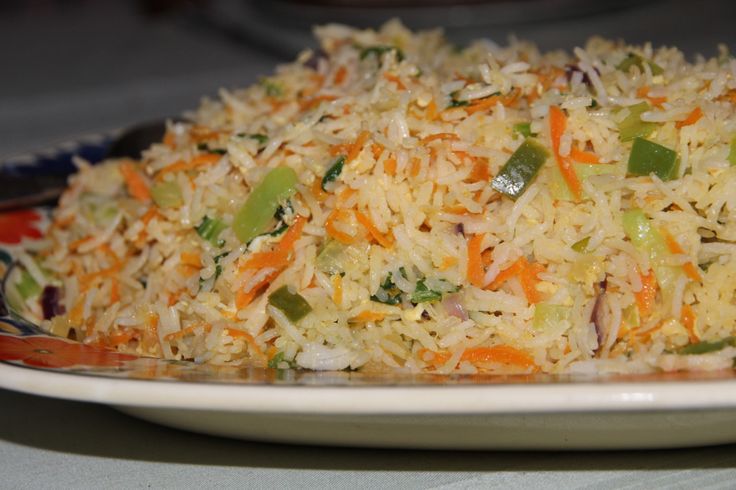 a white plate topped with rice and veggies