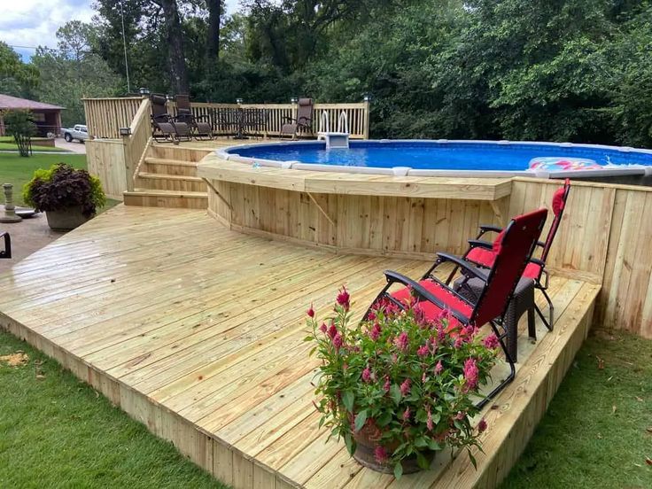 a wooden deck with chairs next to a swimming pool and above ground hot tub area