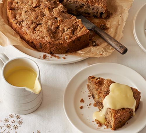 there is a piece of cake on the plate next to some cups and saucers