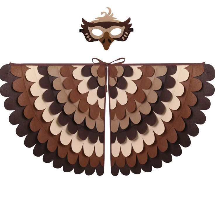 a mask is attached to the wings of an owl's wing with brown and white shapes