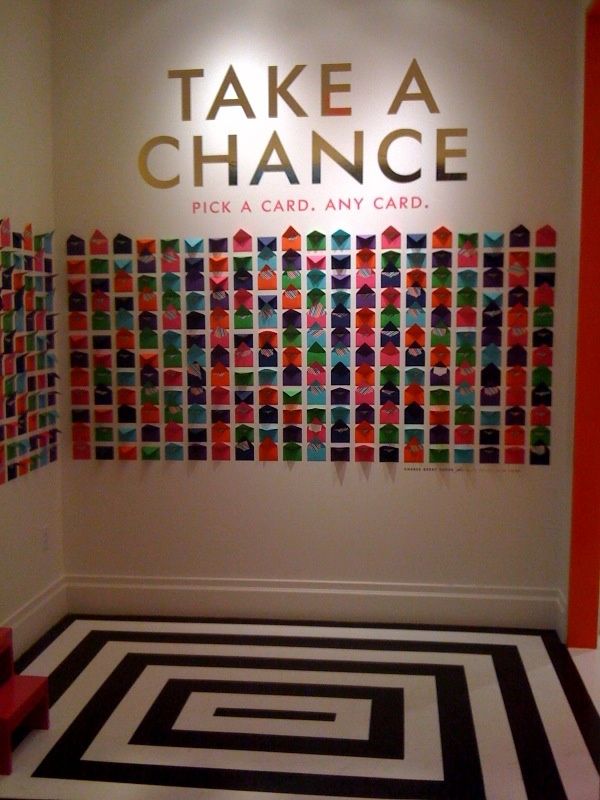 the entrance to take a chance with colorful paper art on the wall and black and white floor