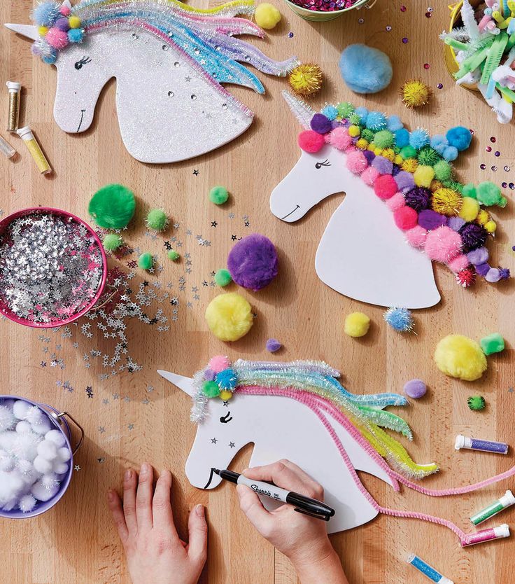 someone is working on crafts with unicorns and pom poms