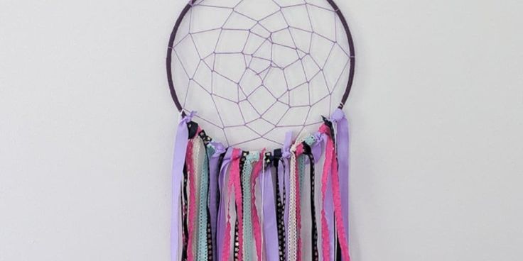 a colorful dream catcher hanging on the wall