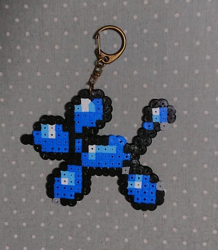 a keychain made out of legos is shown on a polka dot background