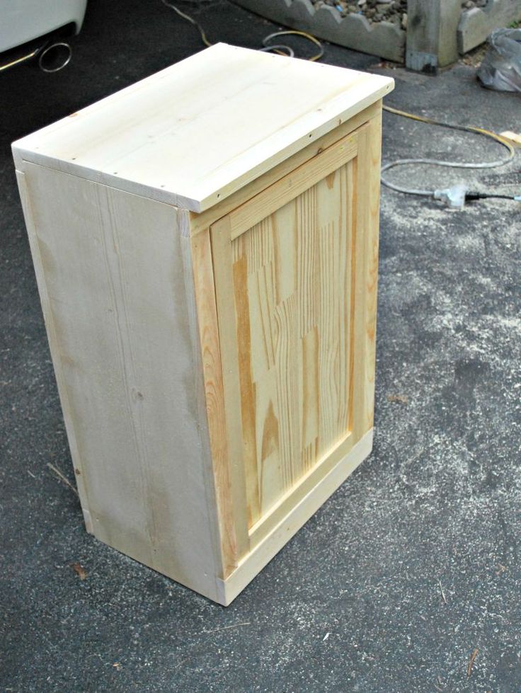 a small wooden cabinet sitting on the ground