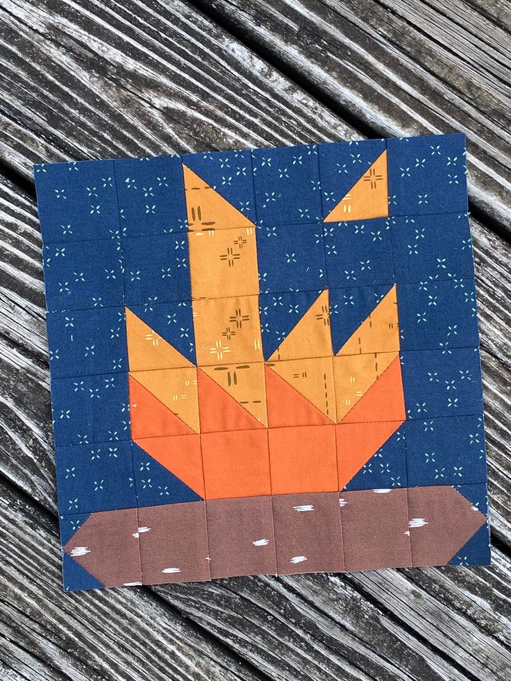 an orange and blue piece of paper on top of a wooden table