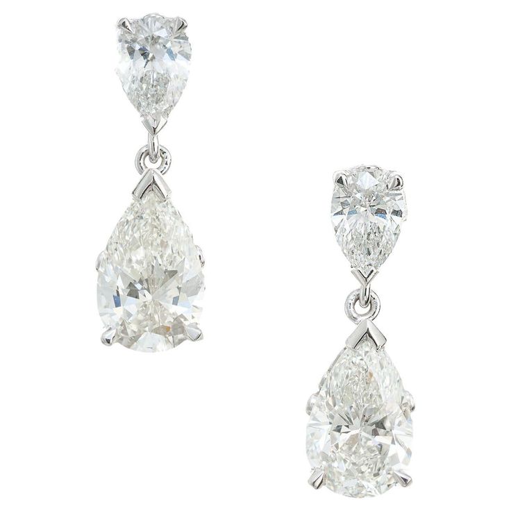 Platinum scroll design pear shape diamond dangle earrings. The bottom two diamonds are GIA certified, with 2 top pear shaped diamonds set in platinum. Designed and crafted in the Peter Suchy workshop 1 pear shape diamond, J SI2 approx. 1.01cts GIA Certificate # 6203805933 1 pear shape diamond, H VS approx. 1.10cts GIA Certificate # 5191709978 2 pear shape diamonds, G-H VS2 approx. .66cts Platinum Stamped: PLAT 3.1 grams Top to bottom: 17.9mm or .70 Inches Width: 5.9mm or .25 Inch Depth or thickn Diamond Tops, Gia Certificate, Vintage Earring, Platinum Rose Gold, Fancy Yellow Diamond, Halo Earrings, Diamond Dangle Earrings, Gold Bracelet Cuff, Diamond Star