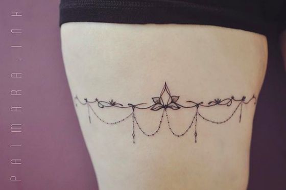 a tattoo on the side of a woman's thigh