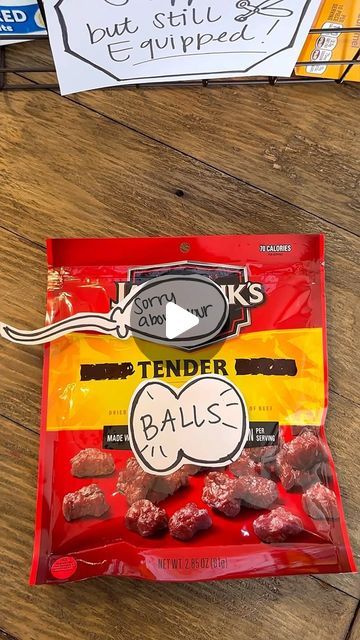 a bag of tender balls sitting on top of a wooden table next to a sign