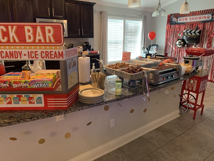 an ice cream parlor with many different types of treats on the counter, including cookies and candy bars