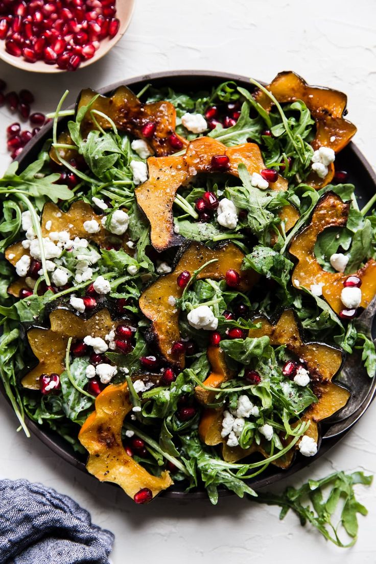 a salad with spinach, feta cheese and pomegranate