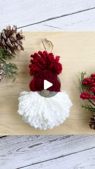 an ornament with a red and white pom - pom on it