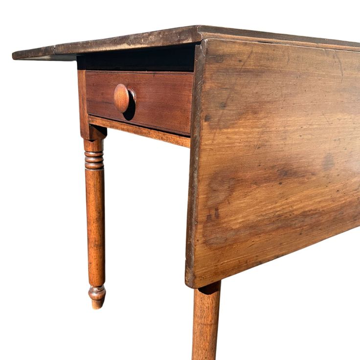 an old wooden desk with one drawer open