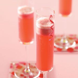 two glasses filled with pink liquid sitting on top of a table