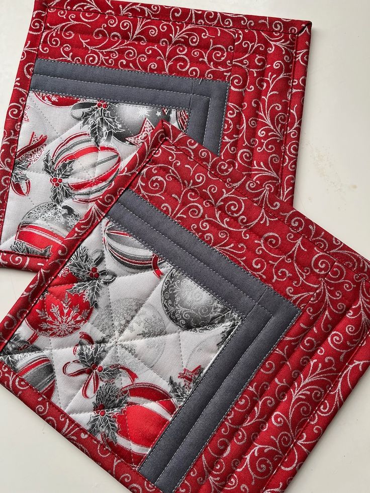 two red and white placemats sitting on top of each other