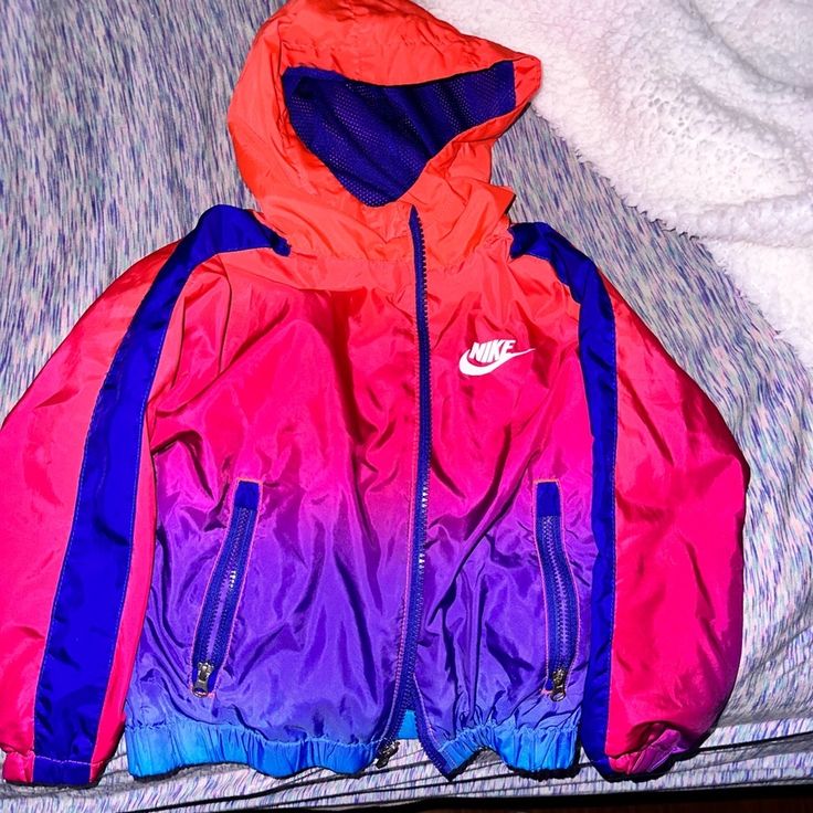 Used But Still In Absolute Perfect Condition. Literally Still Looks Brand New. This Is The Cutest Lightweight Full Zip Nike Jacket. Perfect For Fall Spring Or Winter. It’s So Colorful And Vibrant. It’s Pink Purple And Blue Ombr And With The Right Pair Or Air Max, Or Whatever Nike Kicks You Prefer, It Will Make The Your Little One Look Like The Most Fresh Dressed Around. I’m So Sad My Son Outgrew It. Some Pieces Of Clothing Are Hard To Let Go Of And This Definitely Being One Of Them Nike Pink Sports Outerwear, Purple Hooded Windbreaker With Pockets, Nike Pink Long Sleeve Windbreaker, Purple Fall Sports Windbreaker, Purple Fall Windbreaker For Sports, Pink Nike Windbreaker For Winter, Nike Pink Windbreaker For Winter, Pink Hooded Nike Windbreaker, Sporty Purple Windbreaker With Pockets