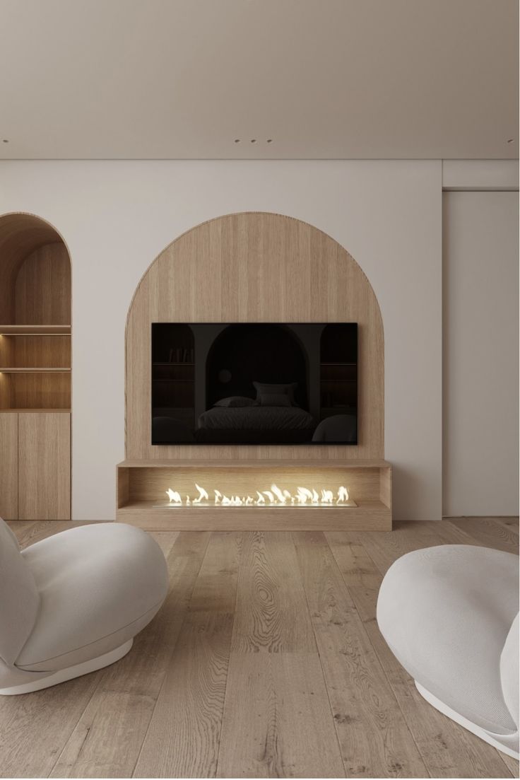 a modern living room with white furniture and wood flooring that has built in shelves