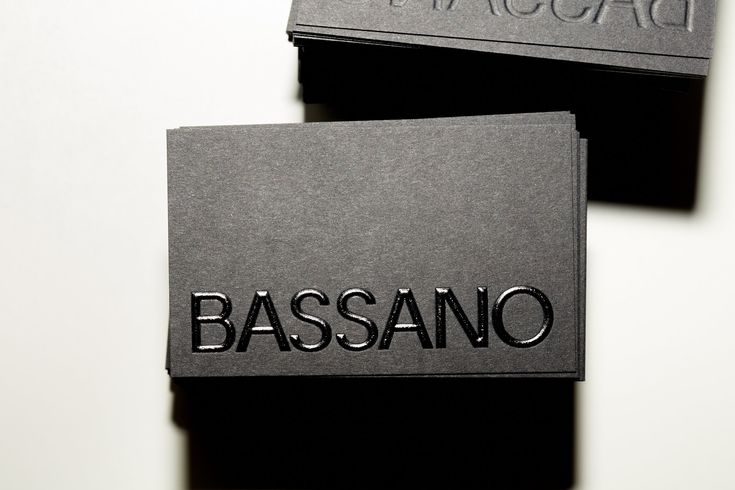 two black business cards with the word bassano on one side and the word paccadi on the other