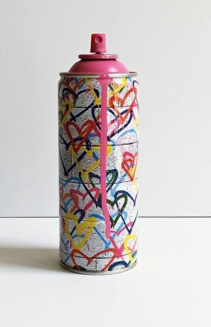 a spray can with colorful graffiti on it