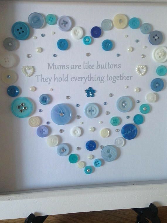 a white frame with buttons in the shape of a heart that says mums are like buttons they hold everything together